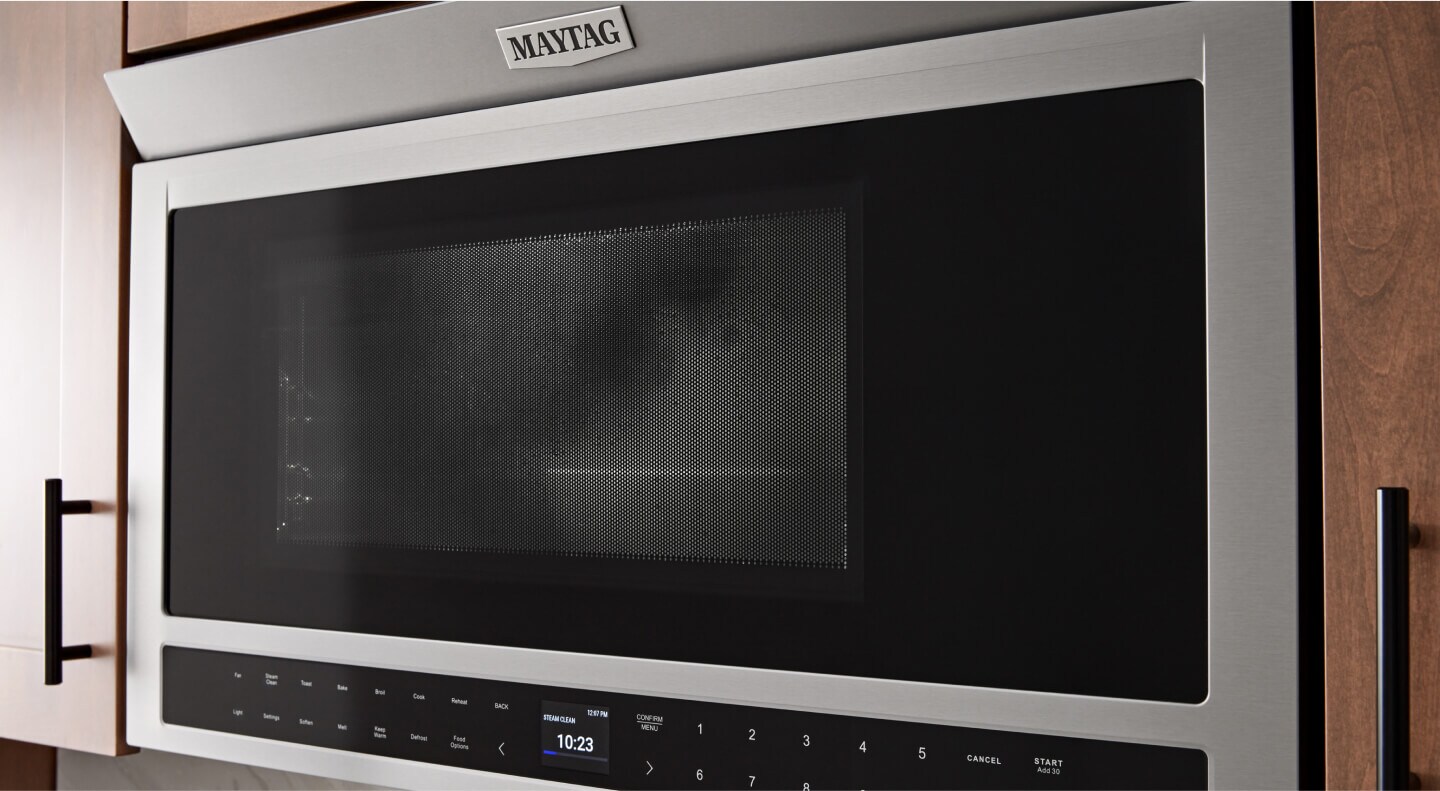 A Maytag® toaster oven installed in brown cabinetry