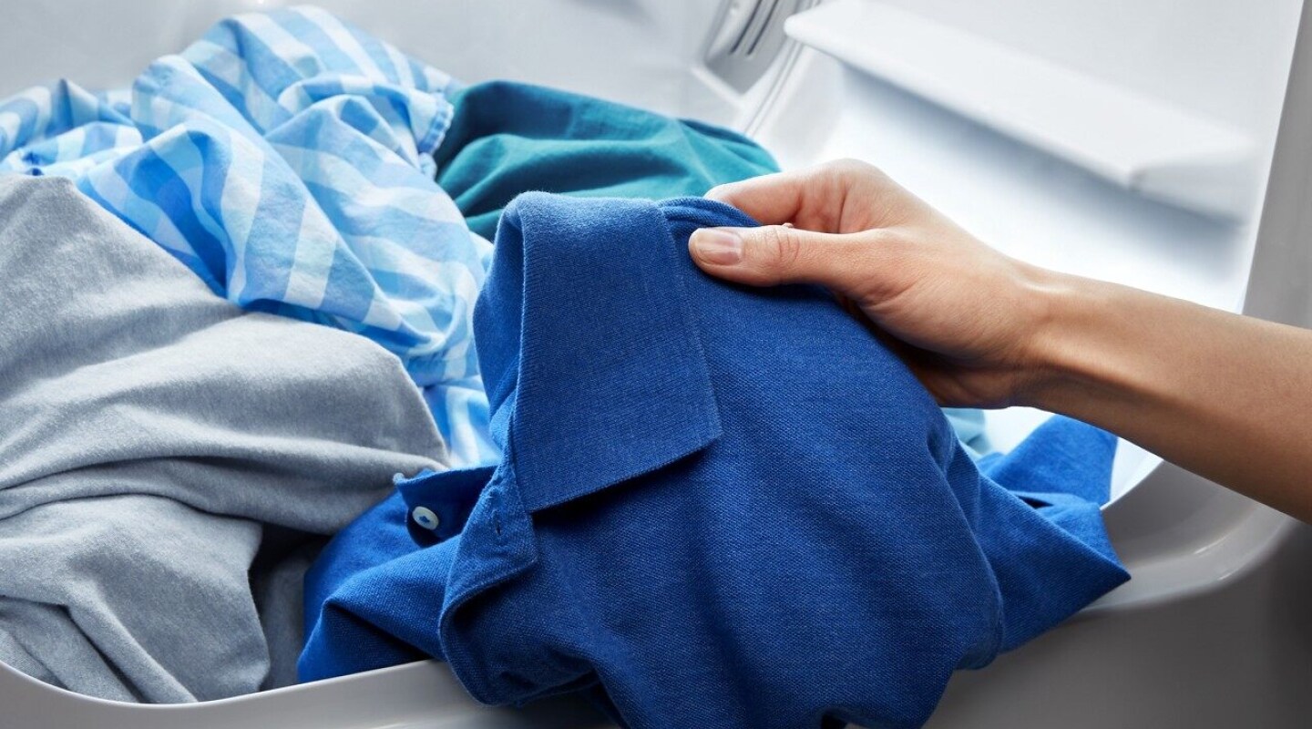 Hand grabbing a blue shirt Hand grabbing a blue shirt
