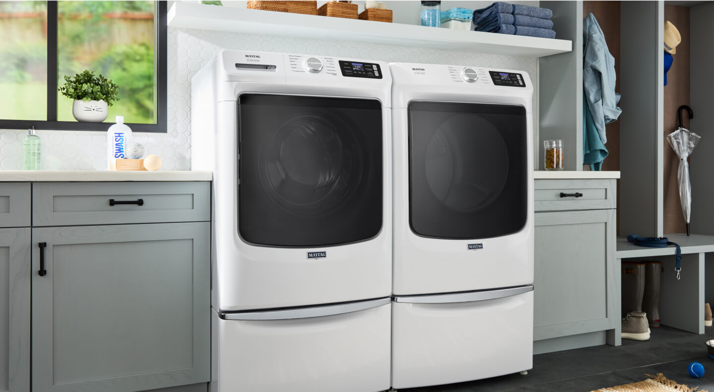 A Maytag® front load washer and dryer in a modern laundry room