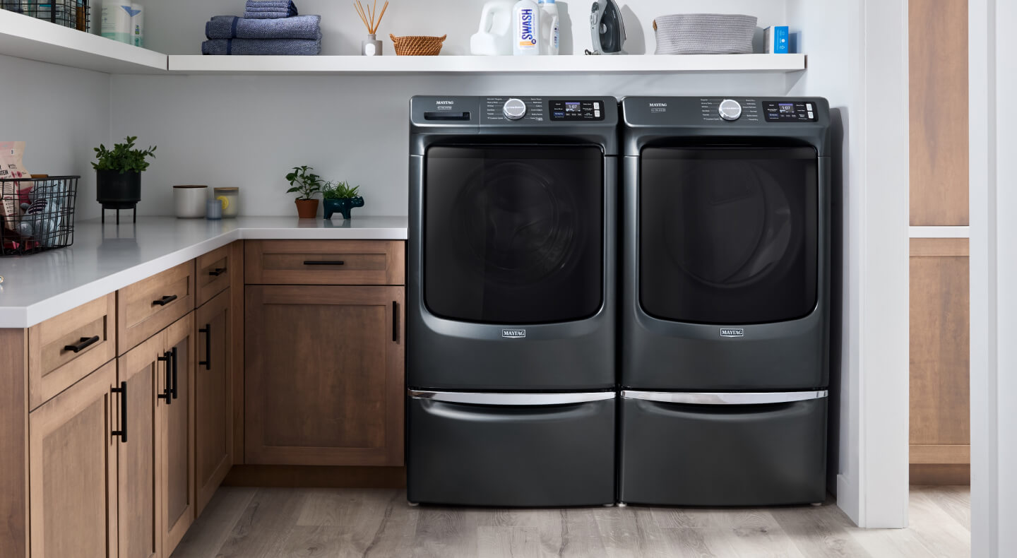 A Maytag® front load washer and dryer in a modern laundry room