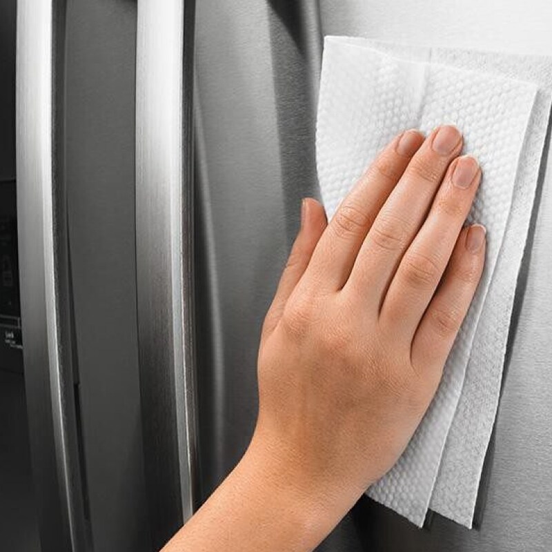 Person buffing streaks out of stainless steel with a clean, dry cloth