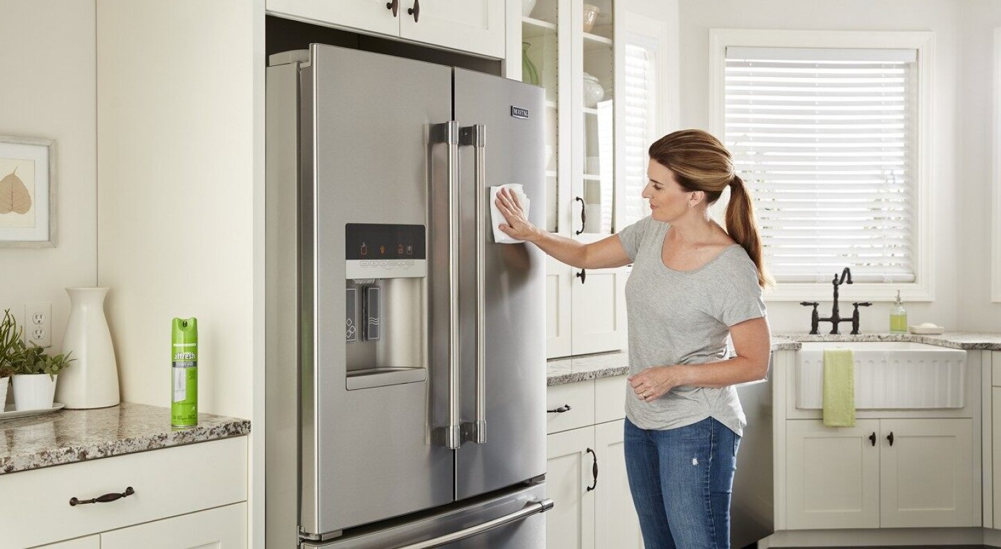 Person cleaning a Maytag® French door refrigerator 