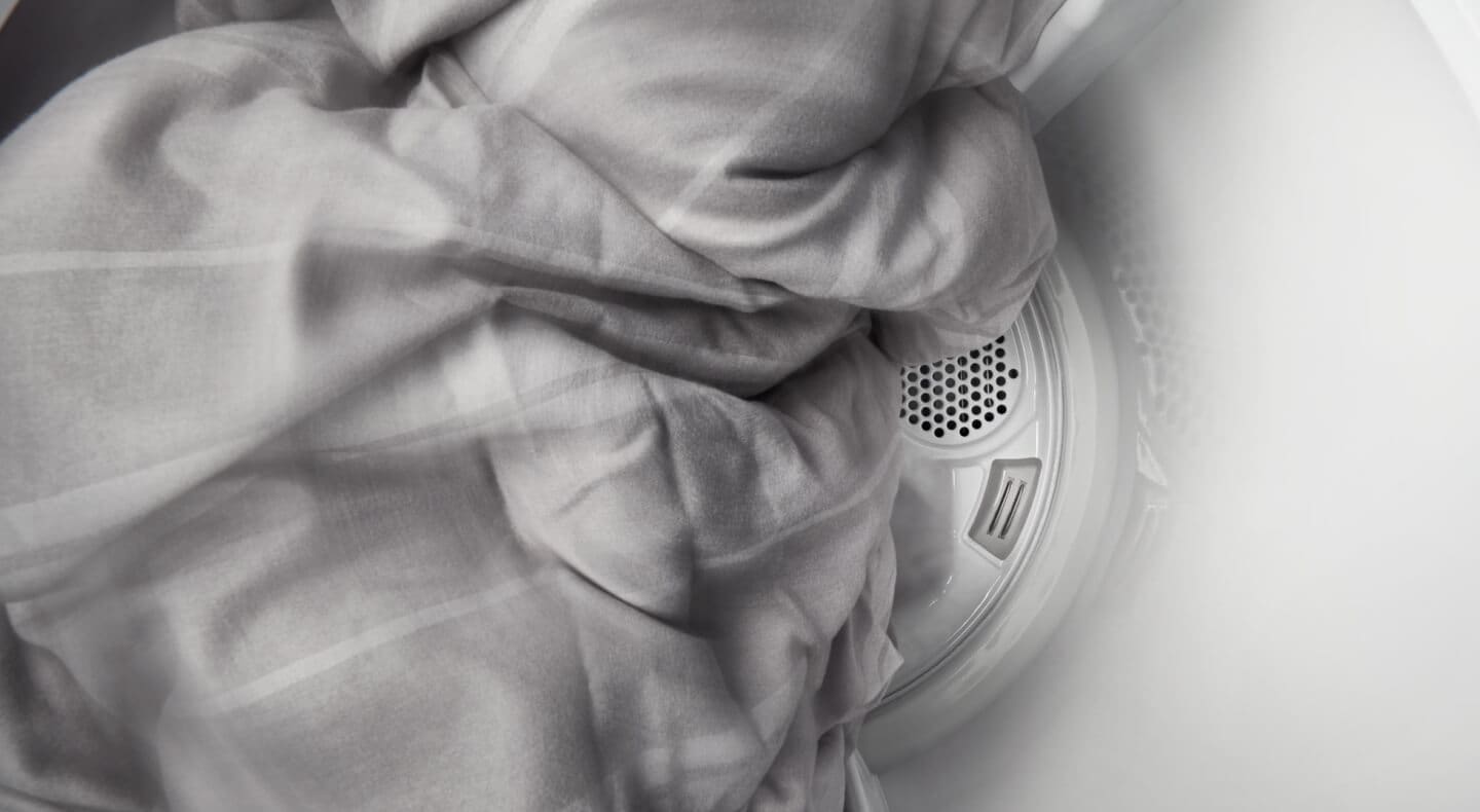 Sheets tumbling in a Maytag® dryer. Sheets tumbling in a Maytag® dryer.
