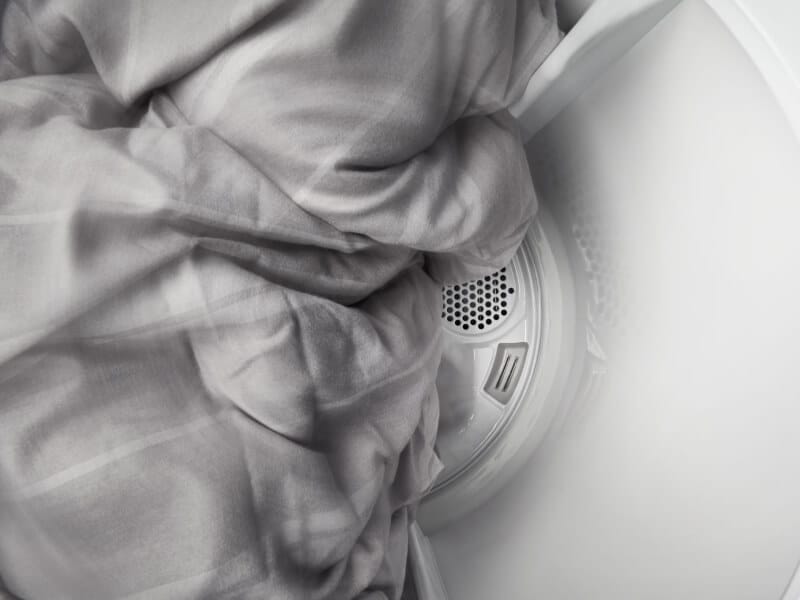 Sheets tumbling in a Maytag® dryer. Sheets tumbling in a Maytag® dryer.