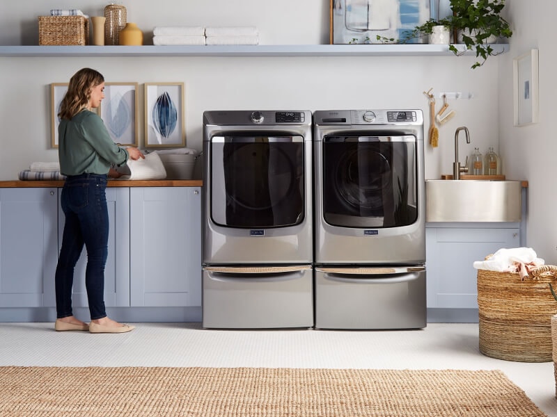 Person standing next to Maytag® laundry pair. Person standing next to Maytag® laundry pair.