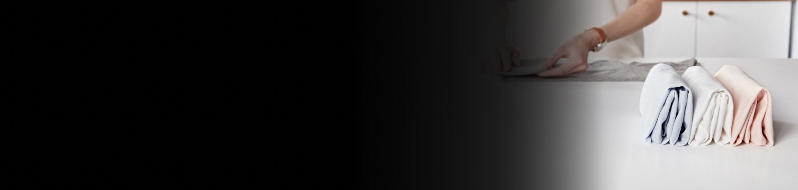 A person folding laundry and lining it up neatly