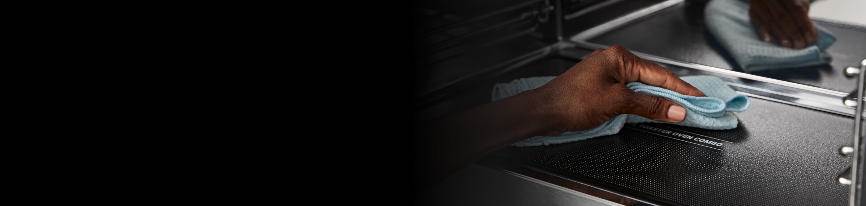 Person cleaning the inside of a Maytag® microwave 