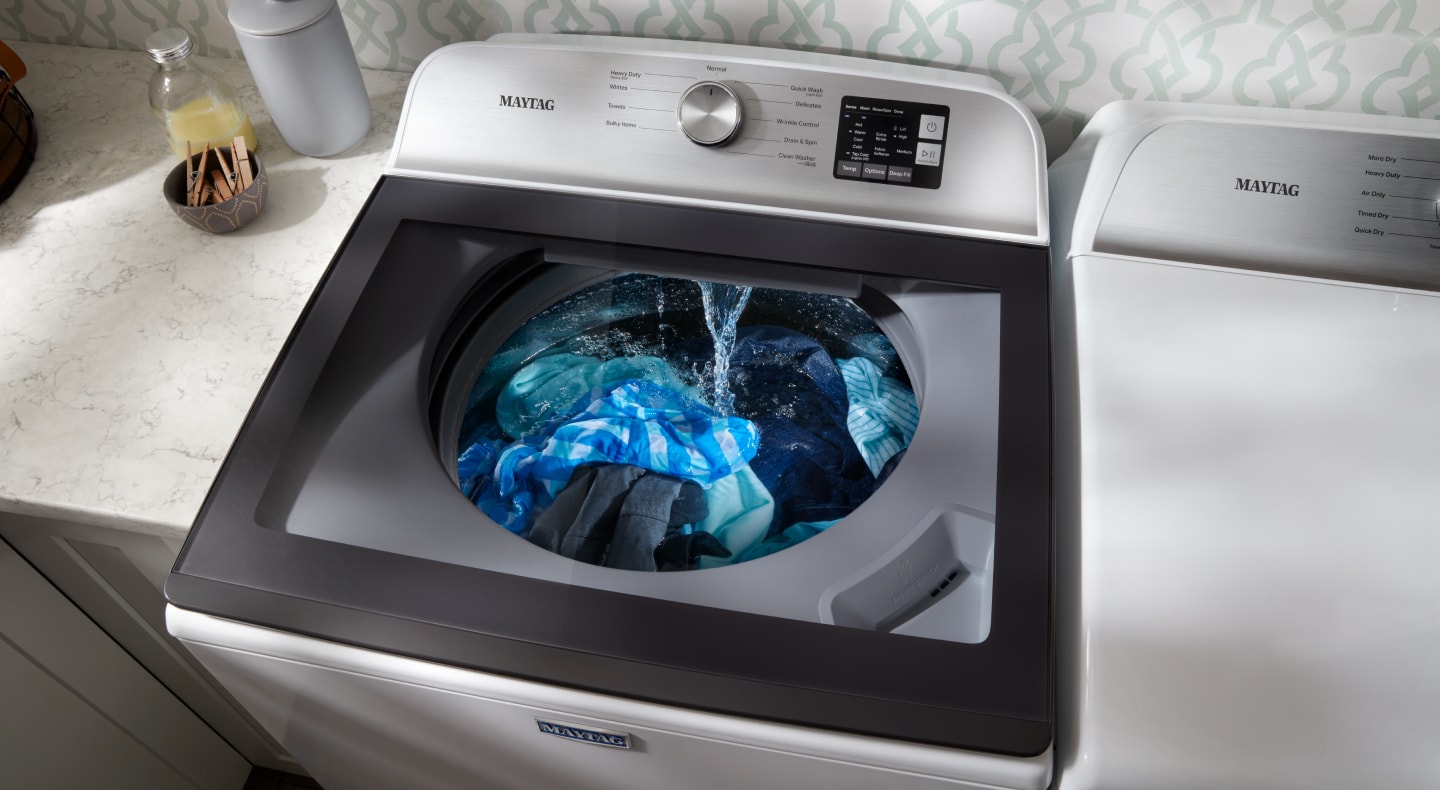 Clothes being washed in a top load washing machine Clothes being washed in a top load washing machine