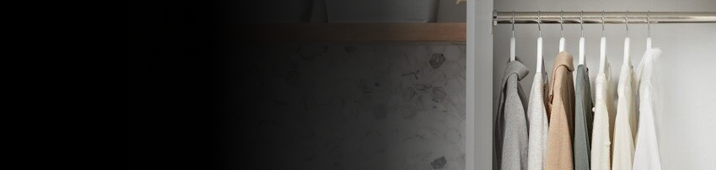 A variety of shirts and tops hanging on a clothing rack