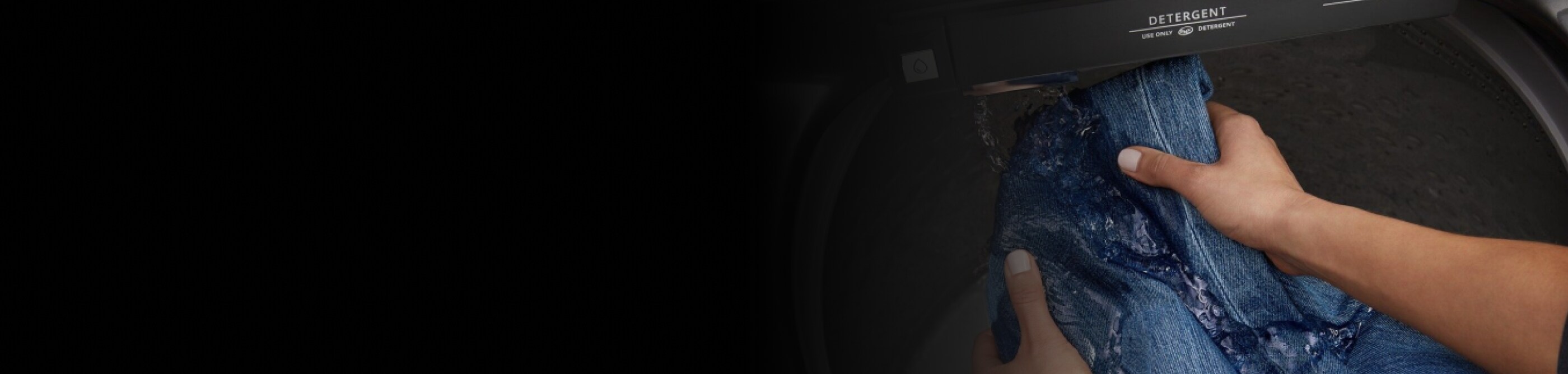 Jeans getting rinsed in the built-in water faucet.