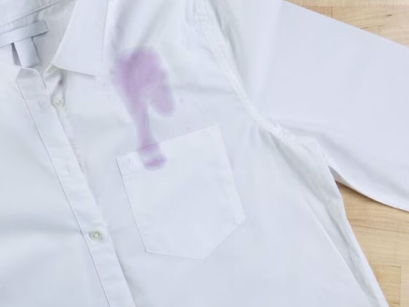 Close-up of purple stain on a white shirt