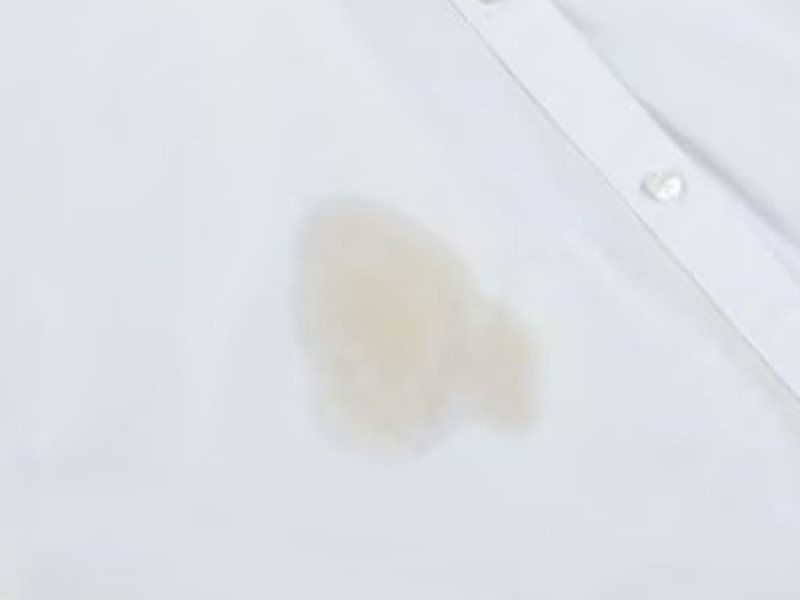 Close-up of coffee stain on white shirt