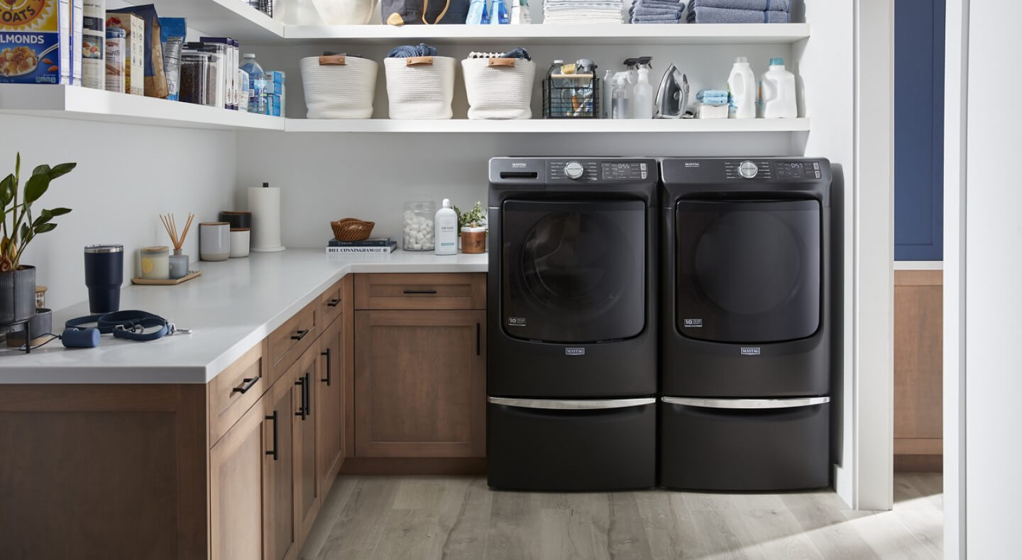 Black Maytag® front-load washer and dryer pair in laundry room