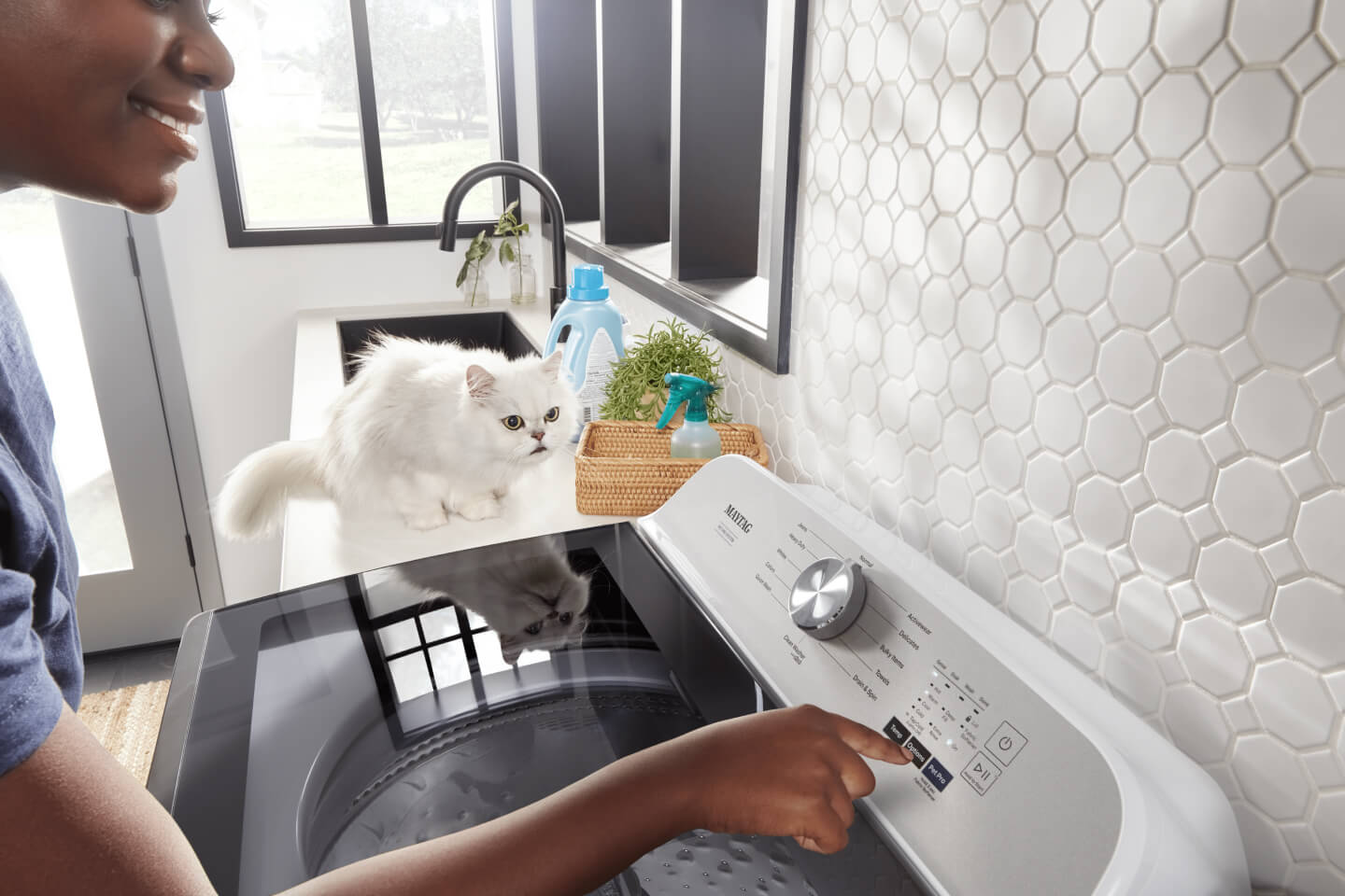 Person starting their Maytag® Pet Pro Top Load Washer