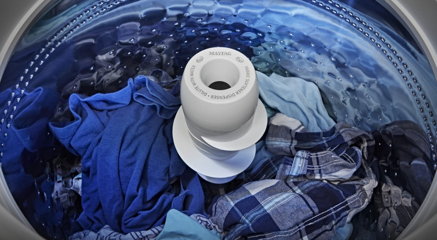 Blue clothes in a top load washer with an agitator