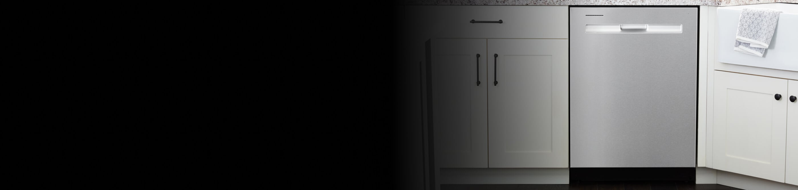A Maytag® dishwasher surrounded by white cabinetry