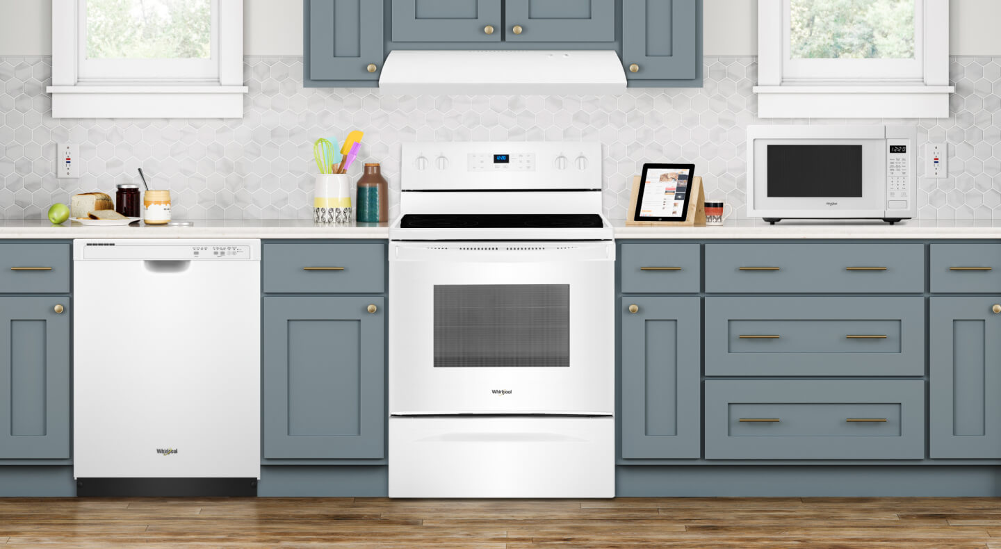 White kitchen appliances set in shaker style cabinets