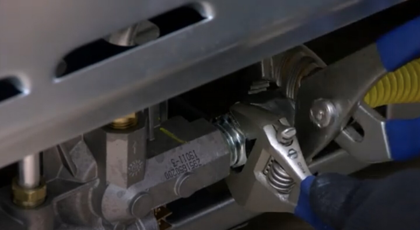 A wrench tightening a gas connector  A wrench tightening a gas connector