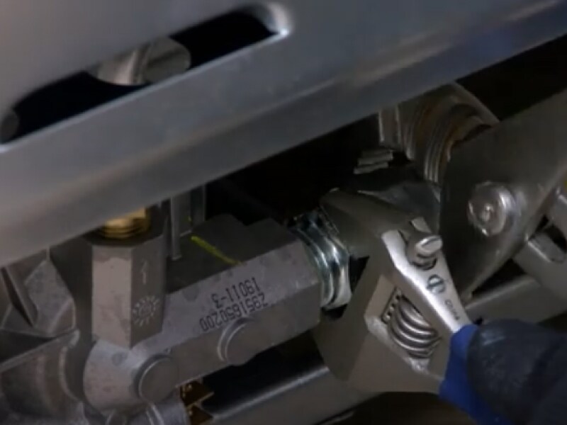 A wrench tightening a gas connector  A wrench tightening a gas connector