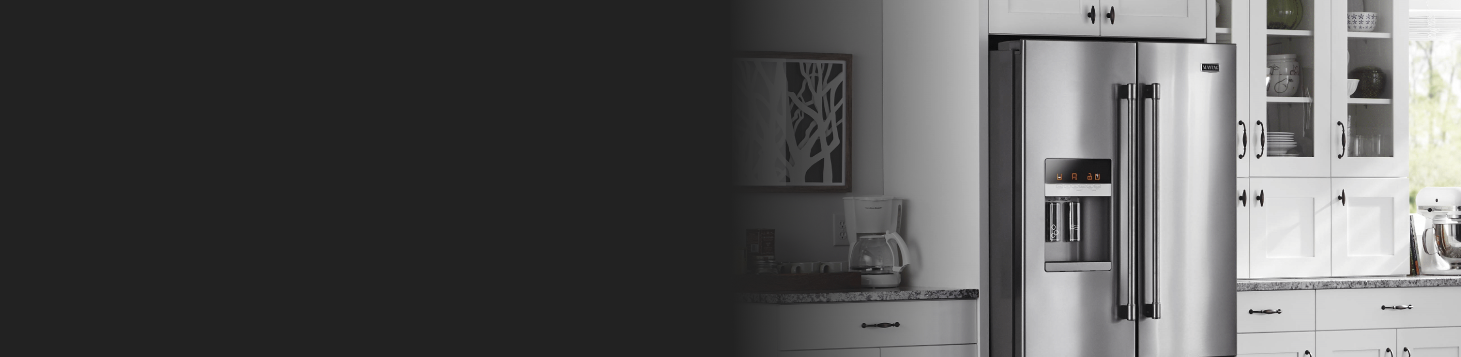 Side-by-side refrigerator from Maytag and a coffee pot on the adjacent counter