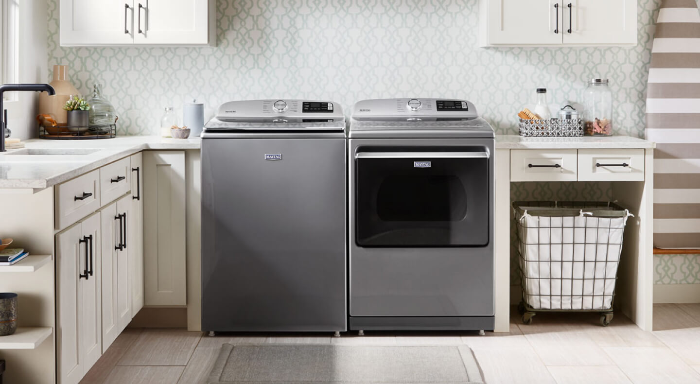 Top load laundry set in a white laundry room.