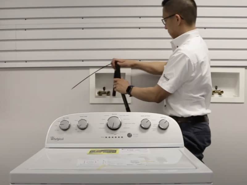 A man placing a drain hose into the standpipe of a Maytag® washing machine. P#: screenshot of video A man placing a drain hose into the standpipe of a Maytag® washing machine. P#: screenshot of video