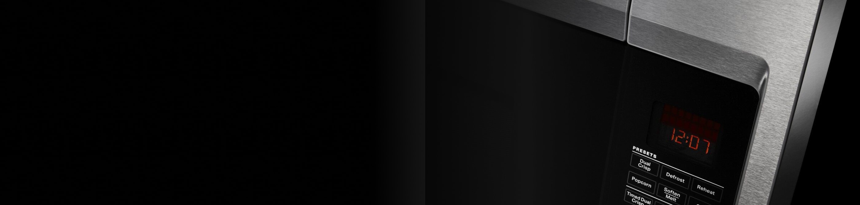 A close up of a microwave door handle and buttons.