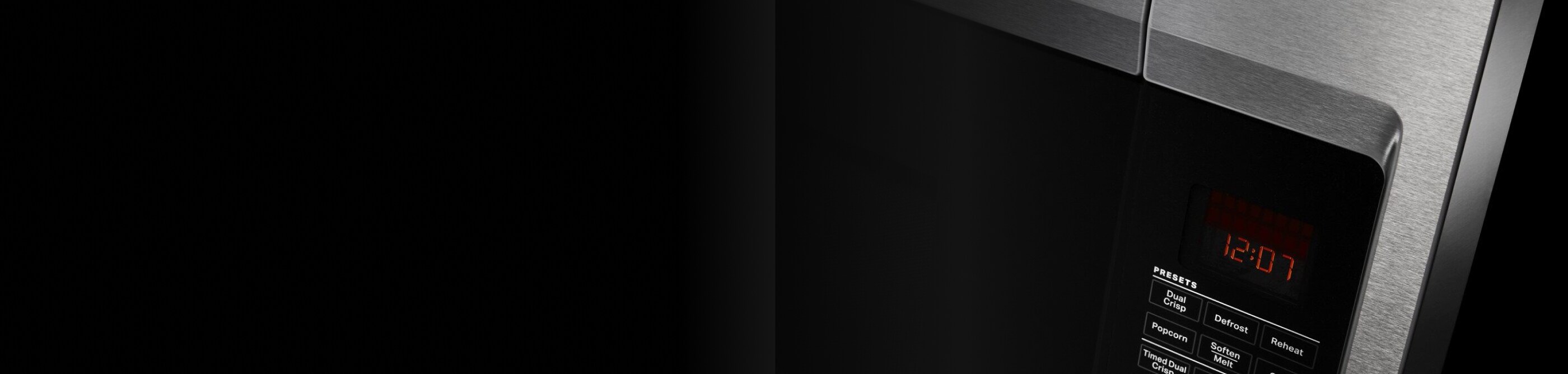 A close up of a microwave door handle and buttons.