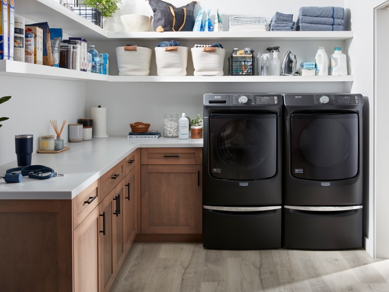 A laundry room featuring a Maytag® washer and dryer A laundry room featuring a Maytag® washer and dryer