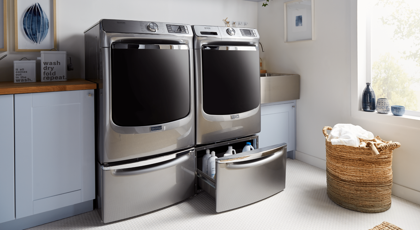 Maytag® washer and dryer on pedestals in a modern laundry room Maytag® washer and dryer on pedestals in a modern laundry room