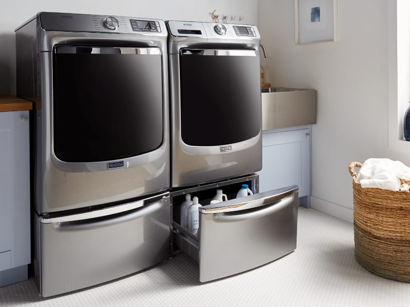 Maytag® washer and dryer on pedestals in a modern laundry room Maytag® washer and dryer on pedestals in a modern laundry room