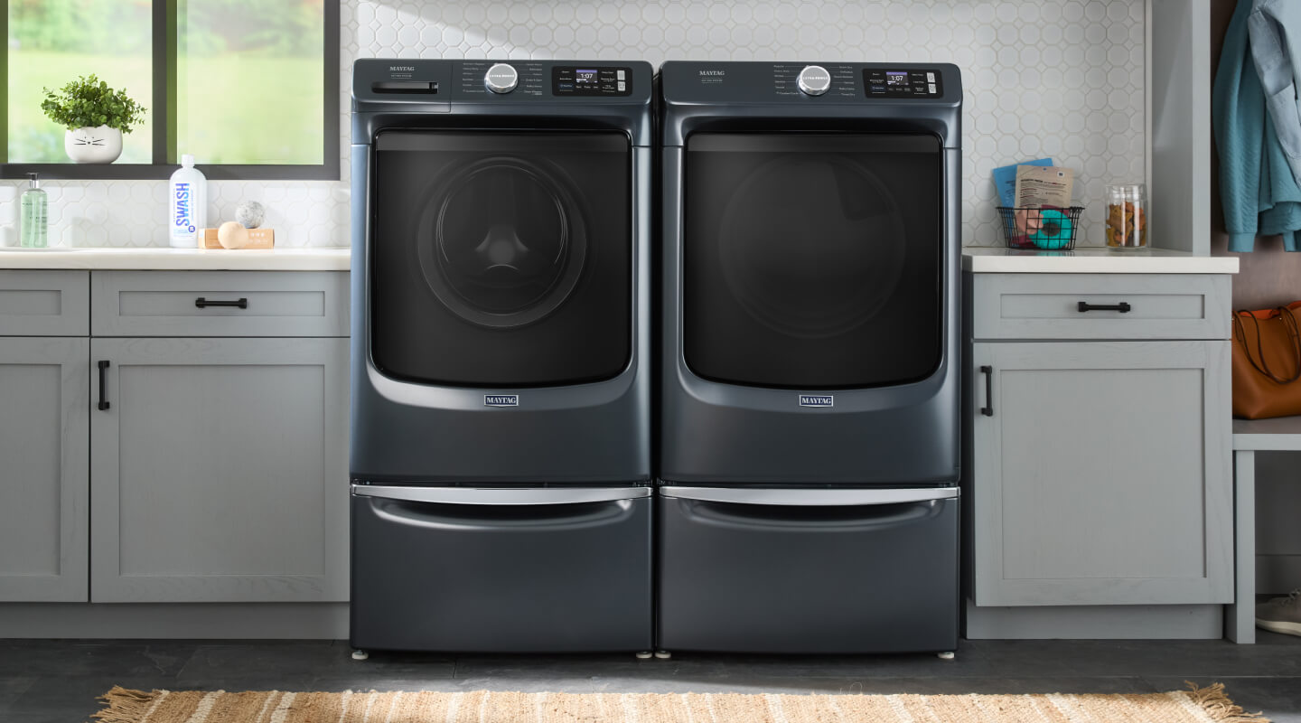 Maytag® front load washer and dryer in a laundry room setting