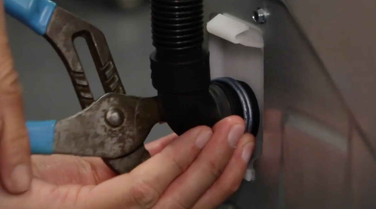 Peron securing a drain hose.