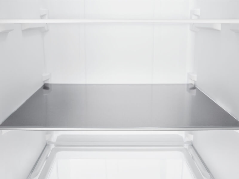 An empty refrigerator shelf