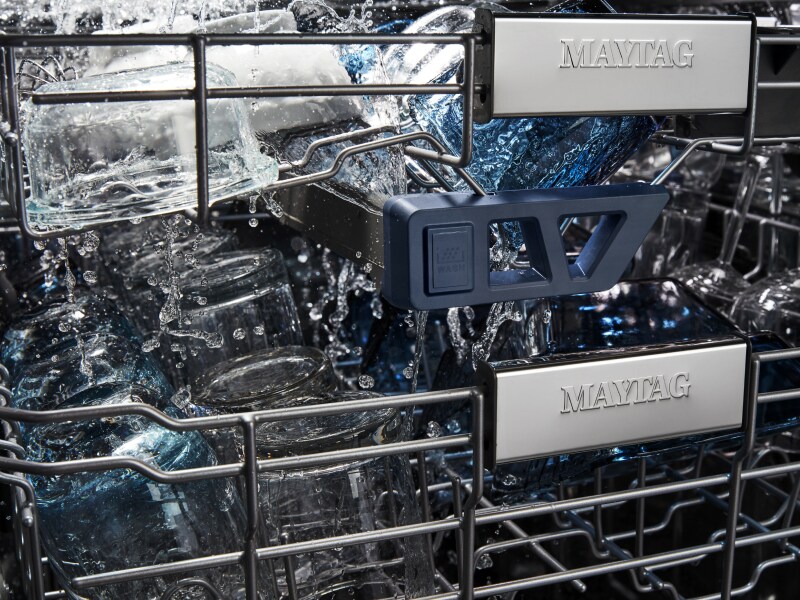 Filled racks of a Maytag brand dishwasher during a cycle. Filled racks of a Maytag brand dishwasher during a cycle.