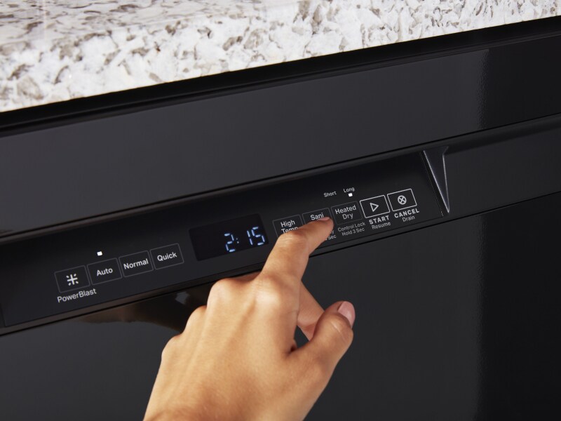 Person adjusting the settings on a Maytag brand dishwasher.