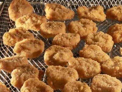 Fried chicken pieces in an air fry basket