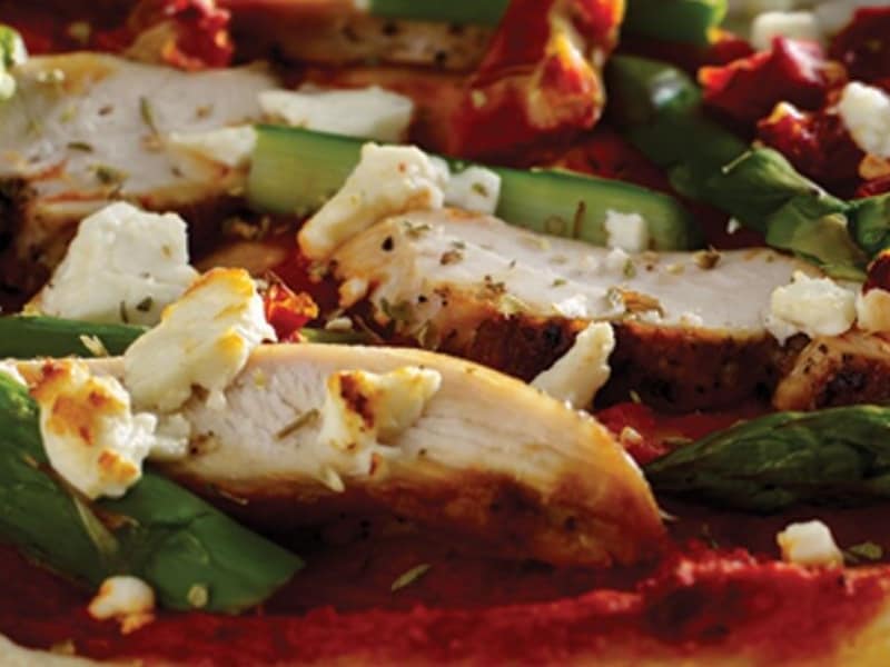 A close-up of chicken and vegetable pizza toppings A close-up of chicken and vegetable pizza toppings