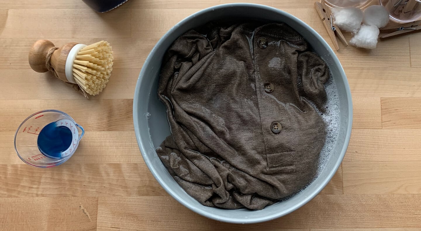 Button up shirt soaking in a bowl of water and detergent Button up shirt soaking in a bowl of water and detergent