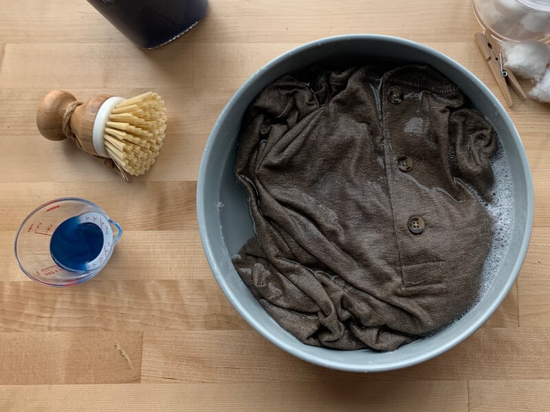 Button up shirt soaking in a bowl of water and detergent Button up shirt soaking in a bowl of water and detergent