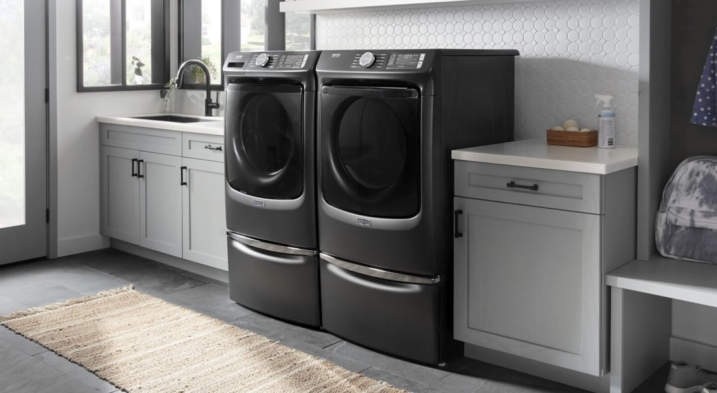Maytag® front load washer and dryer in a laundry room