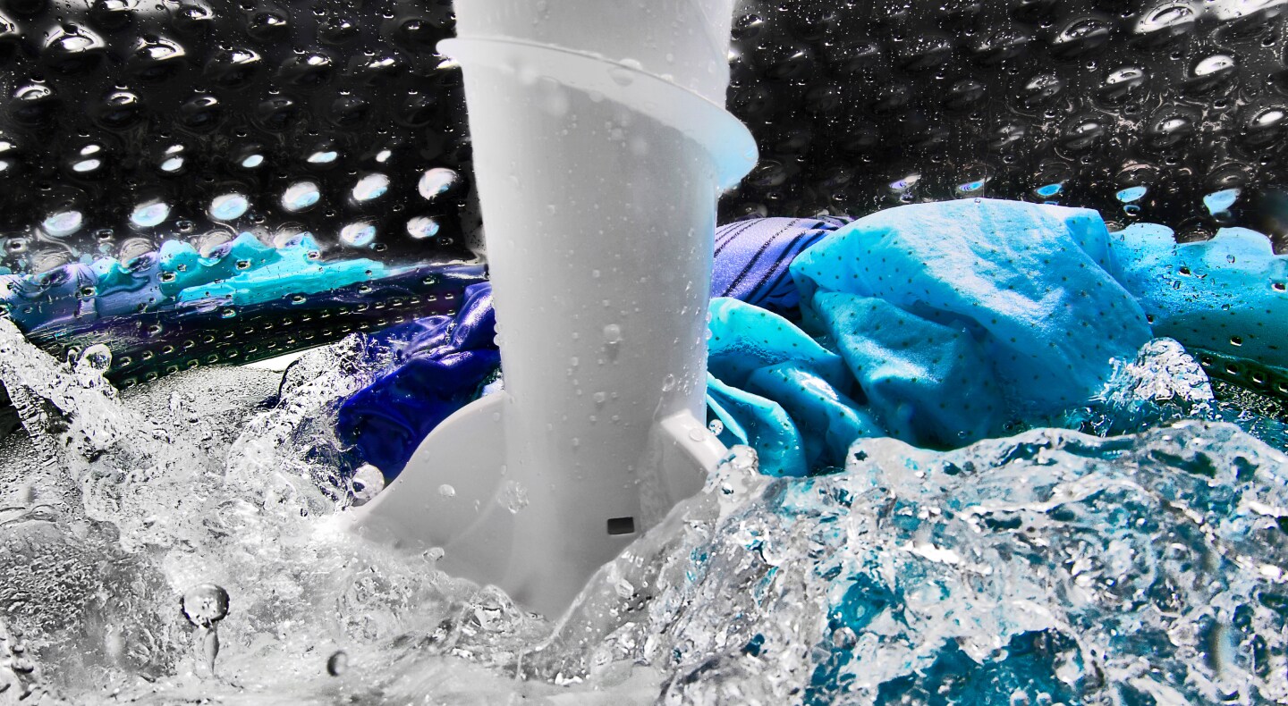 Clothes inside a washing machine with an impeller Clothes inside a washing machine with an impeller