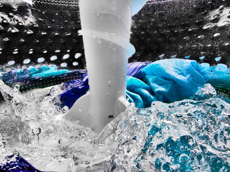 Clothes inside a washing machine with an impeller Clothes inside a washing machine with an impeller