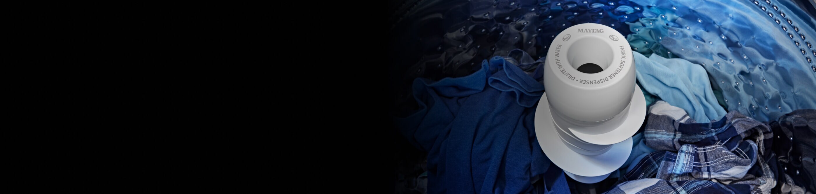 Agitator surrounded by blue clothes in Maytag® top load washer