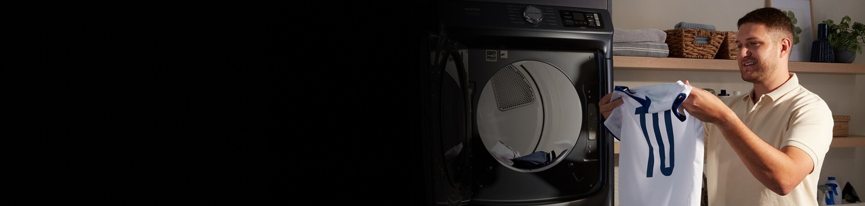 Person removing a jersey from a dryer