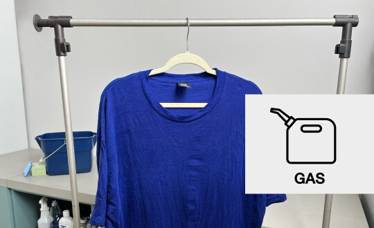 Blue t-shirt hanging on a clothing rack