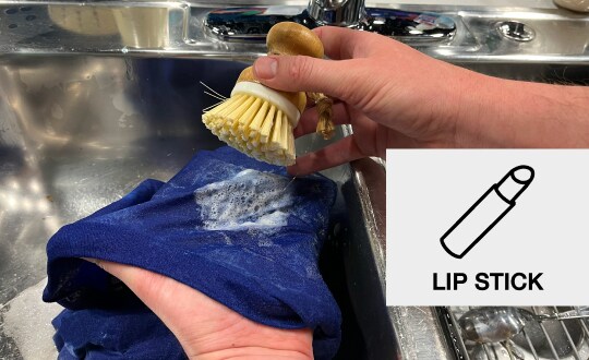 Person spot-treating a stain with a soft-bristled brush