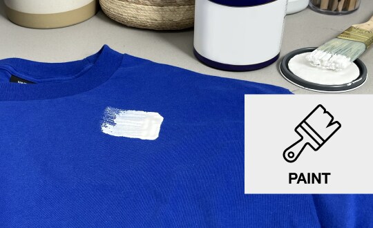 Blue t-shirt with a white paint stain