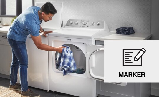 Person placing laundry in a dryer
