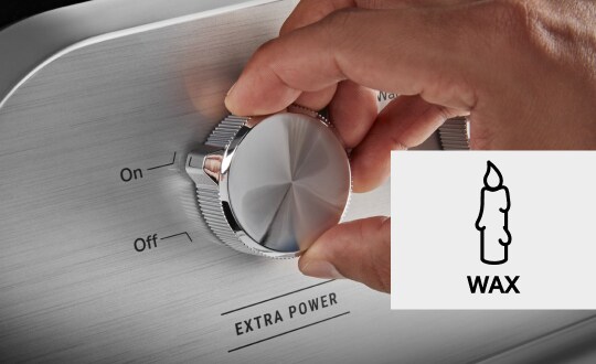 Person selecting a wash setting on a washer control panel